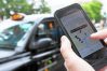 A user scans for an available vehicle using the Uber Technologies Inc.'s app on an Apple Inc. iPhone 5 smartphone in this arranged photograph in London, U.K., on Friday, May 30, 2014. London's taxis are planning a 10,000-cab protest next month, as professional drivers across Europe demonstrate growing opposition to the Uber app. Photographer: Chris Ratcliffe/Bloomberg ** Usable by CT and LA Only **